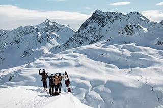 Fabio Studer enjoying a bluebird day with friends after fresh snowfall.